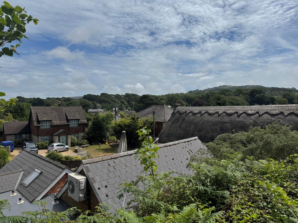 Lot: 75 - VILLAGE CENTRE LAND WITH POTENTIAL AND EXISTING SUMMER HOUSE - A View From the Site over the Rooftops of Godshill